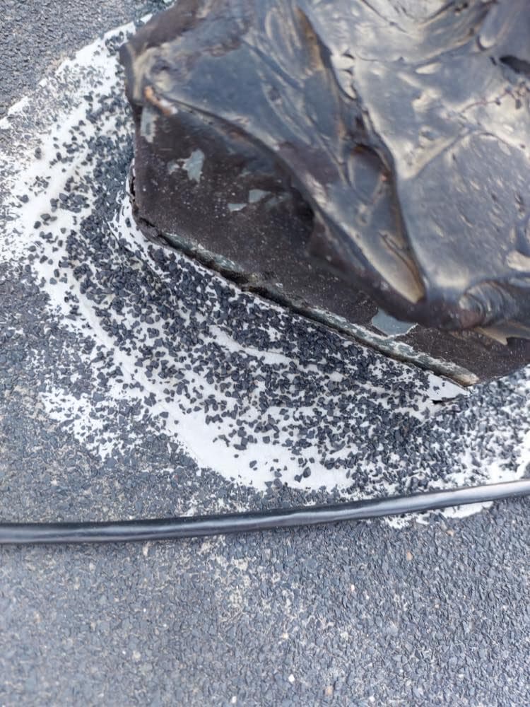 Failed pitch pocket with cracked mastic on a modified bitumen flat roof