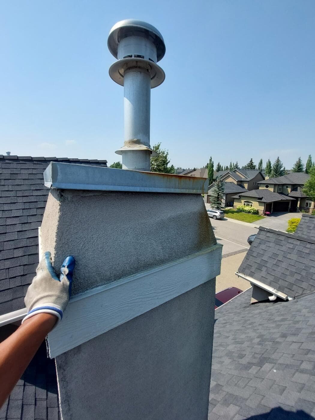 New flashing fitted around a chimney on a Calgary roof