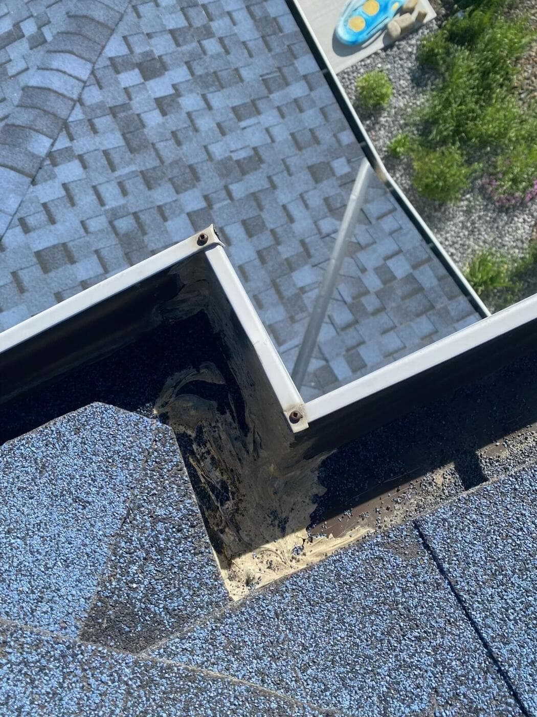 Rotted roof decking exposed at a valley on a Calgary home