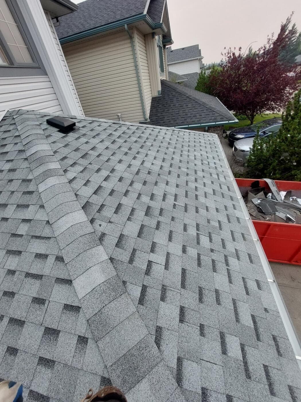A Calgary roofing job in progress with the disposal bin on site