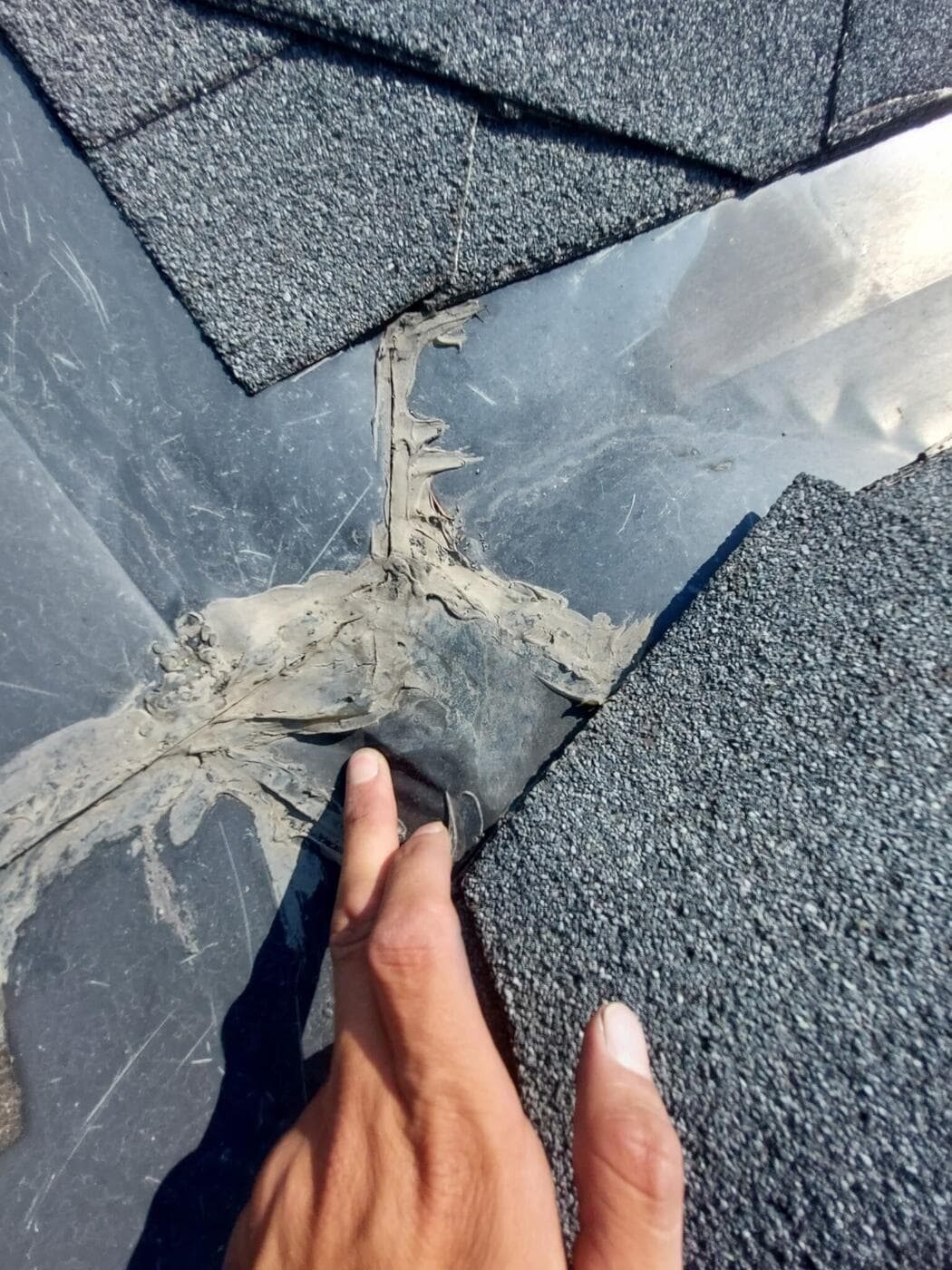 Cracked sealant at a roof valley on a Calgary home, found during inspection