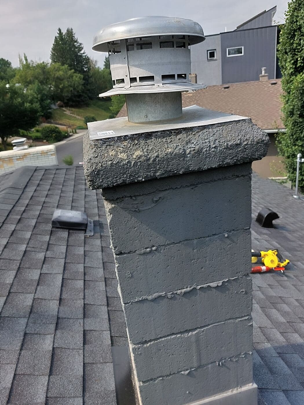Chimney stack and vent cap showing deteriorated flashing detail