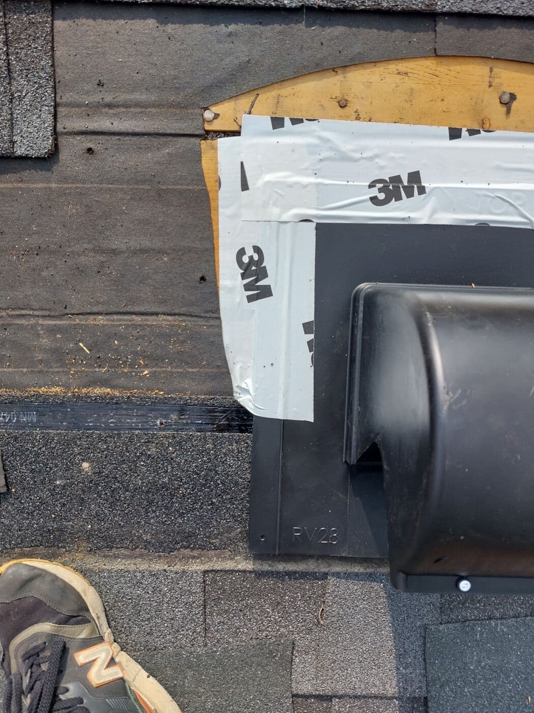 New vent boot flashed into the shingle courses on a Calgary roof
