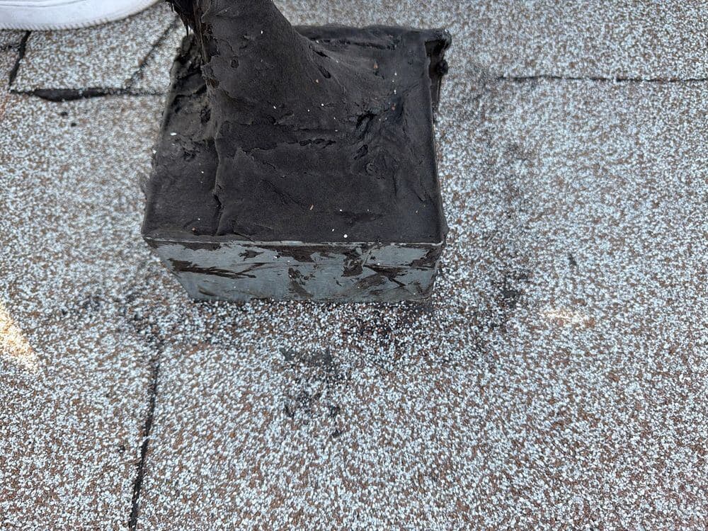 Mastic pitch pocket around a roof penetration on a commercial flat roof